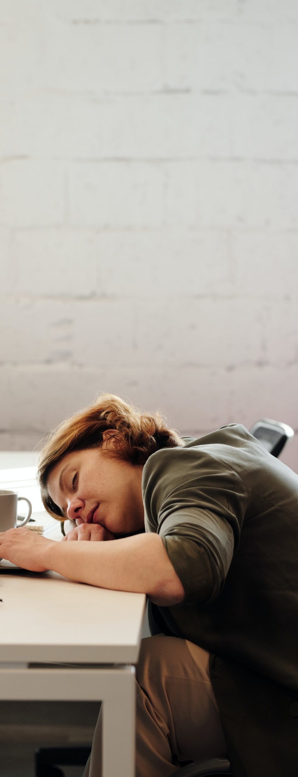 photo-of-woman-leaning-on-her-desk-4064169